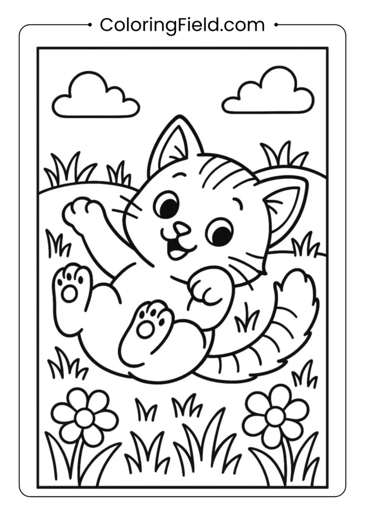 Cute kitten rolling playfully on the grass.